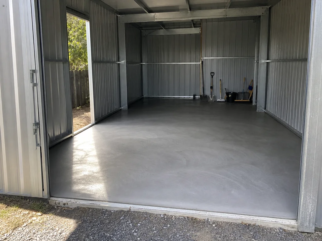 Finished concrete floor inside a steel garden shed